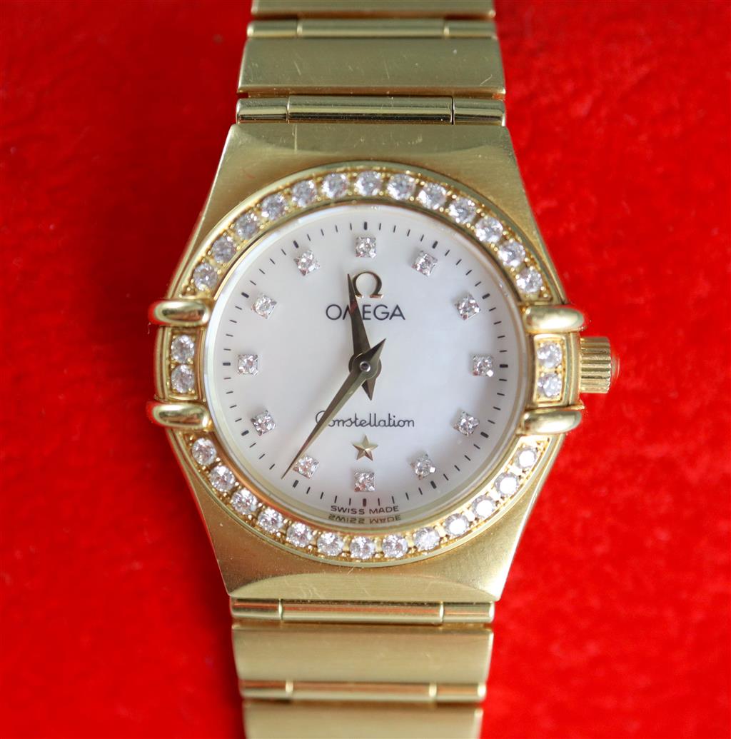 A ladys 1990s 18ct gold Omega Constellation quartz wrist watch with diamond set mother of pearl dial and bezel,